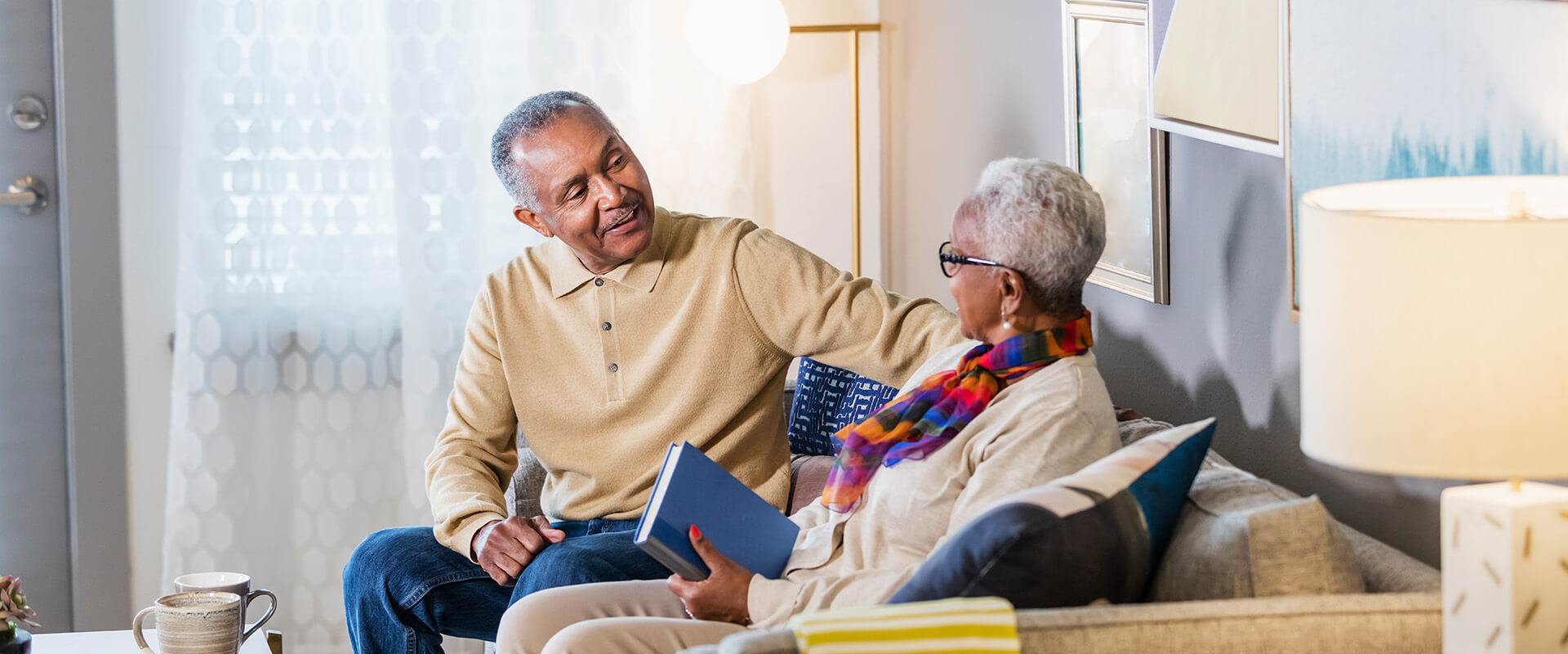 Senior couple having a conversation in their living